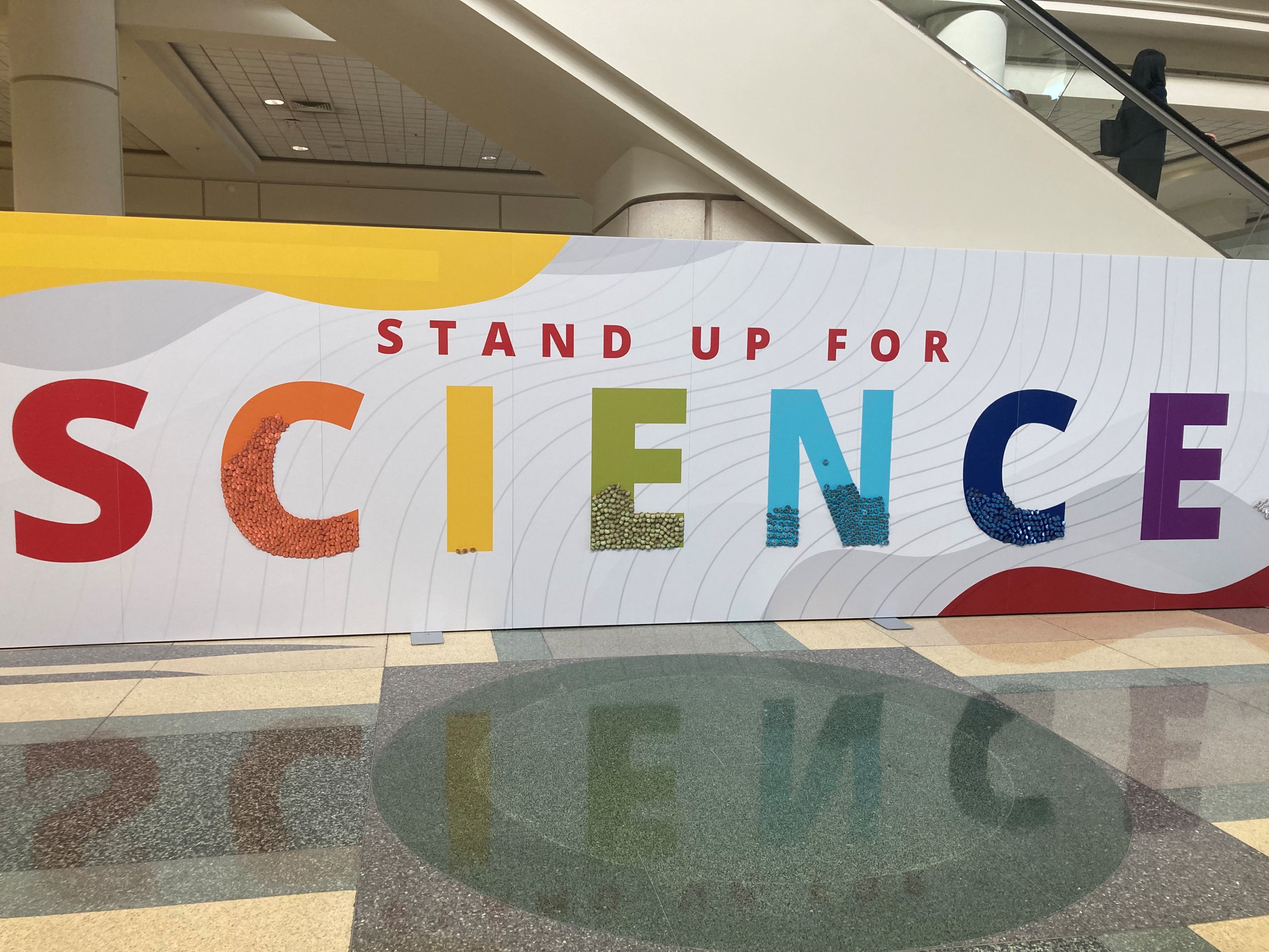 A mural at ASH 2025 reading Stand Up for Science