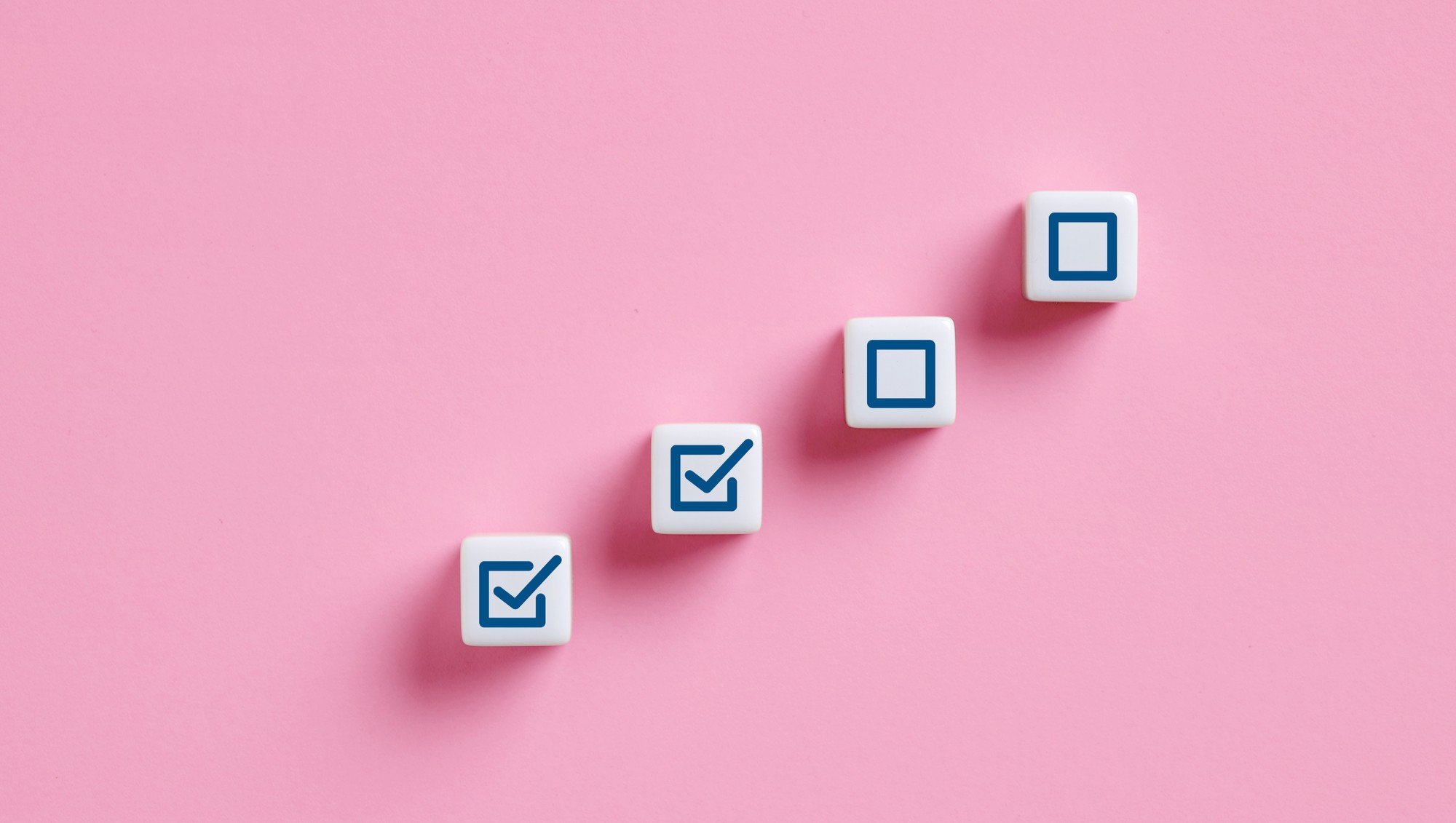 Completing steps towards success checkmark on cubes symbolizing progress 