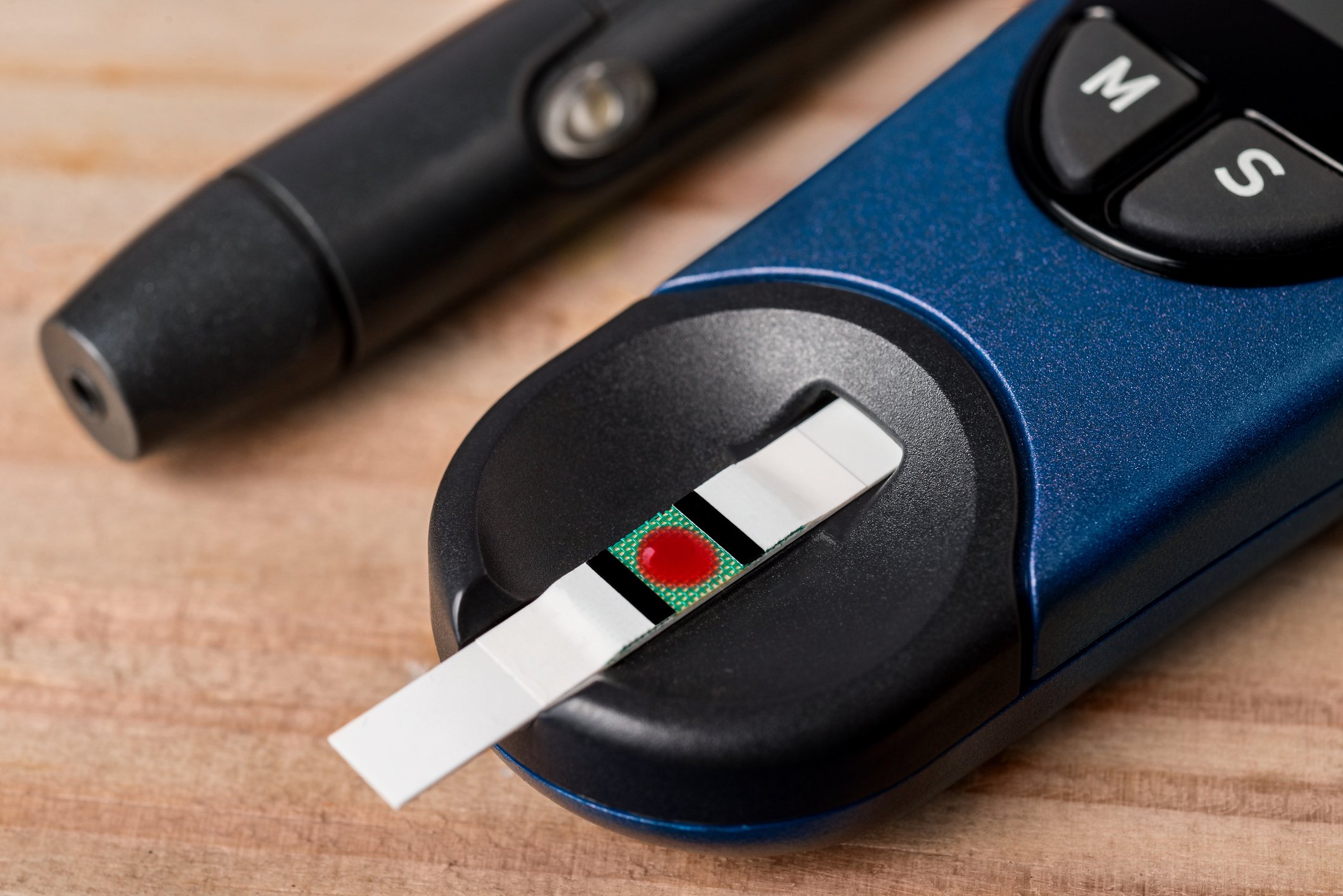 stock image of a glucose meter with a blood strip